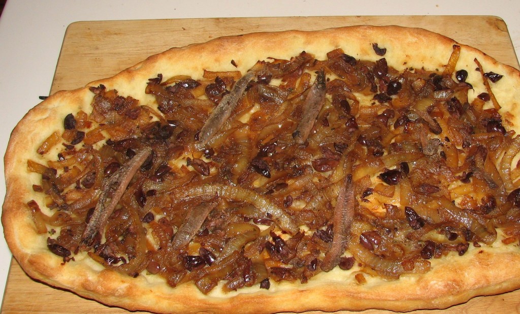 Pissaladiere with rough cross-hatching of anchovies, Nicoise olives